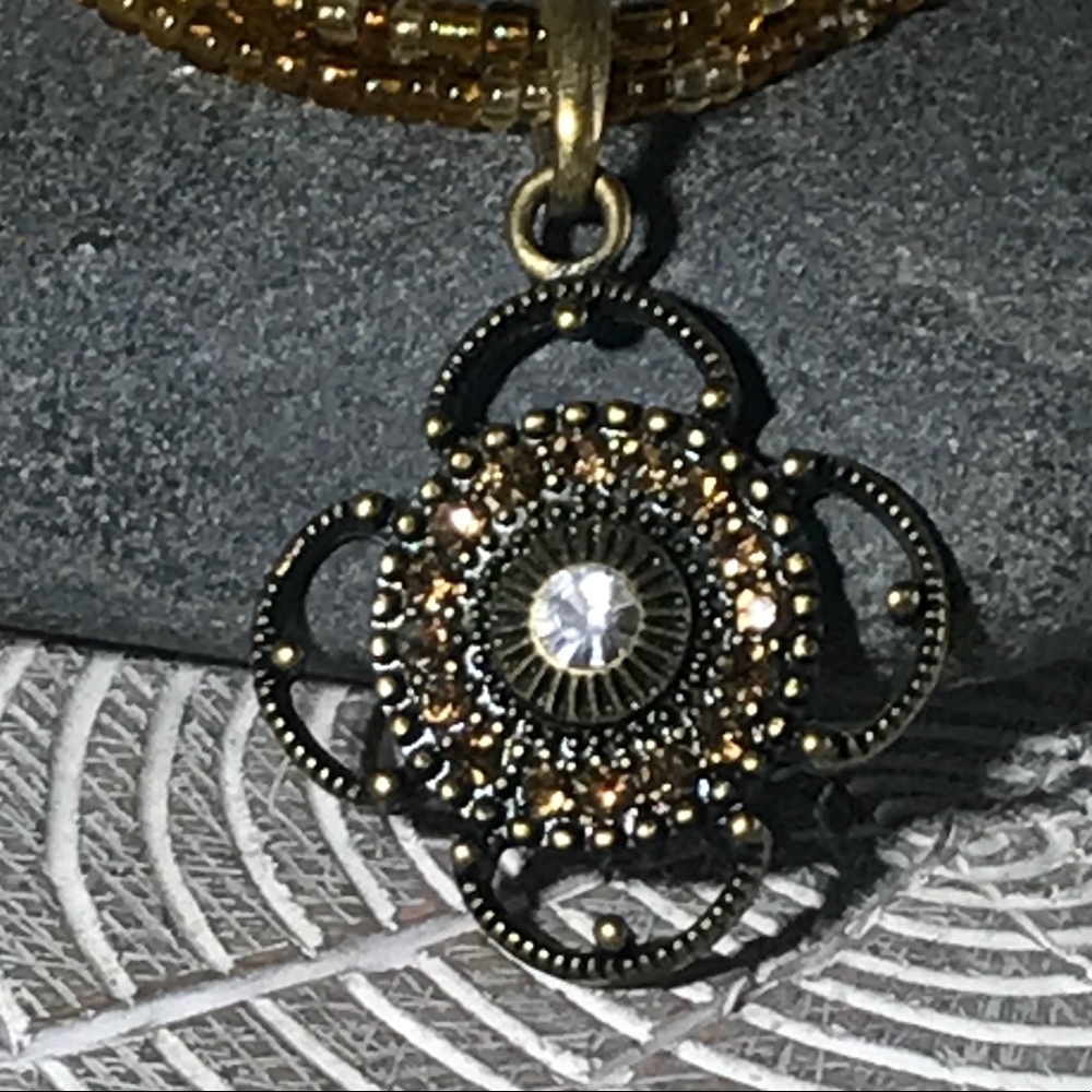 Yellow-gold beaded necklace w/ rhinestone pendant
